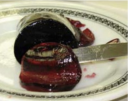 jelly on a plat being cut with a knive