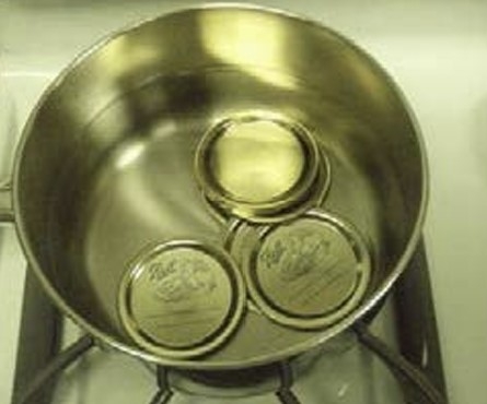 lids in a pan of water