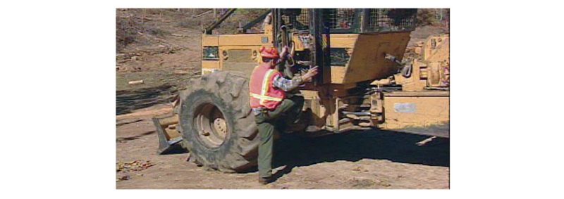a photo of a person getting on a skidder