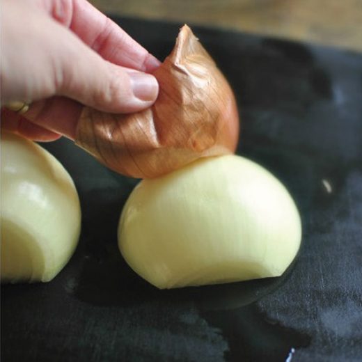 Photo of peeling an onion cut in half