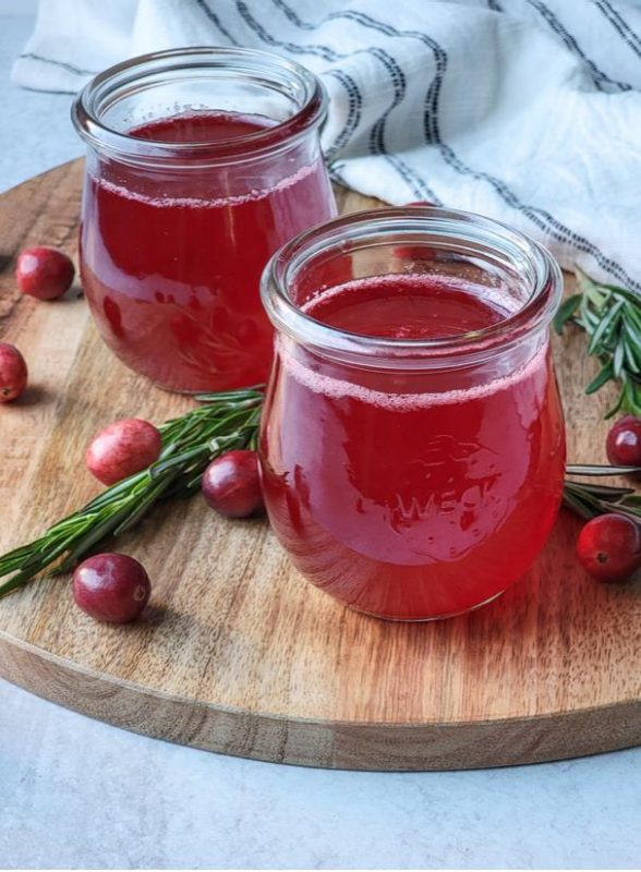 A glass jars with hoppy cranberry simple syrup.