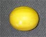 Large round yellow melon on a grey surface