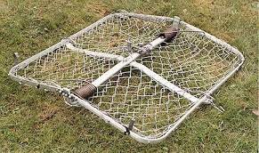 An open, square-shaped trap with a metal frame around chain-link wire hinged with springs in the center. 