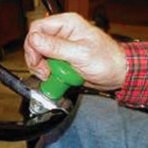 A hand operating a green spinner know.