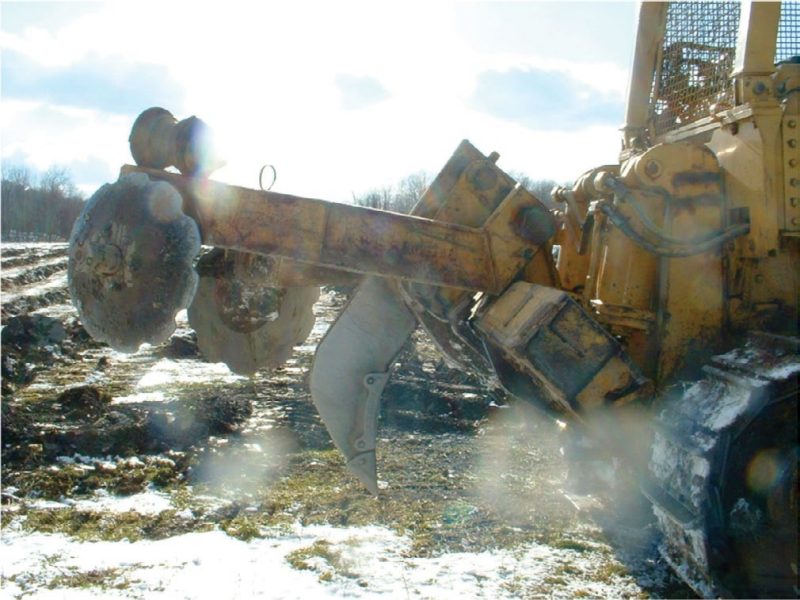 Figure 6. An example of a soil ripping tool (Savannah-type plow) used to prepare several mine sites in Wise County, Virginia, for reforestation in late 2007. The ripping shank is 36” long and the large steel wheels on the end of the shaft behind the ripping shank (“coulters”) are 30 inches in diameter. The coulters are intended to push a mound onto the top of the ripped channel, where trees can be planted.