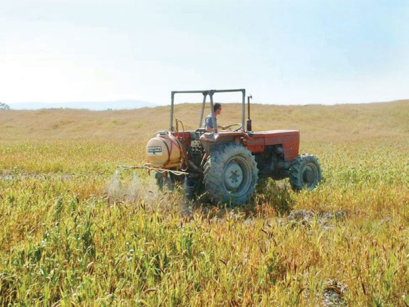 Figure 4. A tractor applying herbicide to a former mine site with little or no woody vegetation.