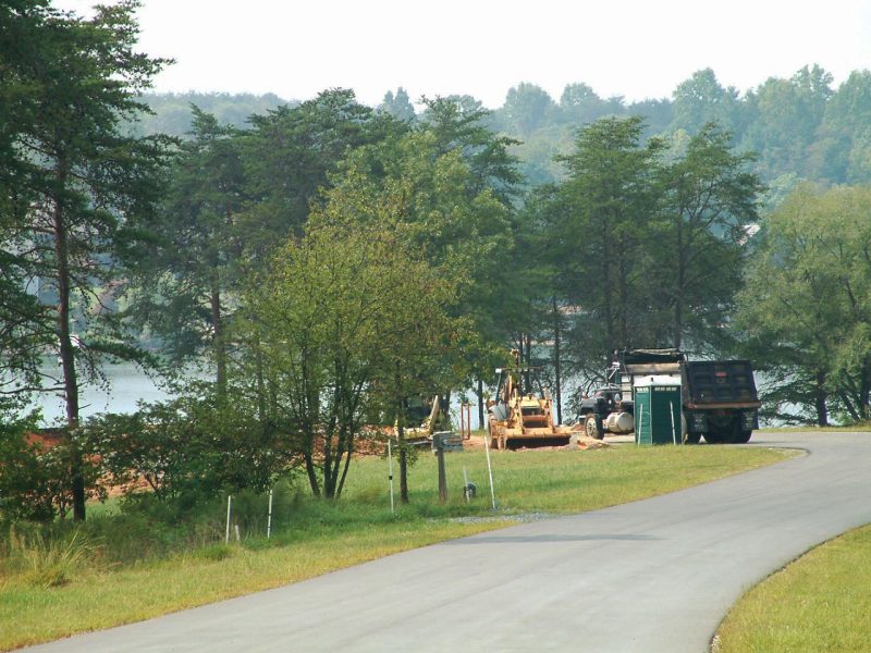 Two photos. The first shows many real estate for sale signs of varying colors and styles ont he side of the road pointing to the direction of homes for sale and the second shows a cleared and developed landscape with construction activity and infrastructure, illustrating forest fragmentation and land conversion.