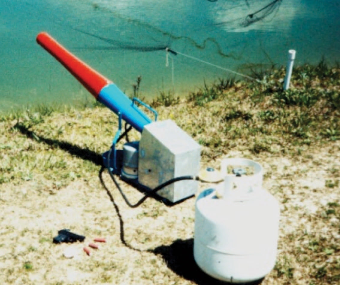 photo of netting, propane cannons, and hand-held noisemaker under water