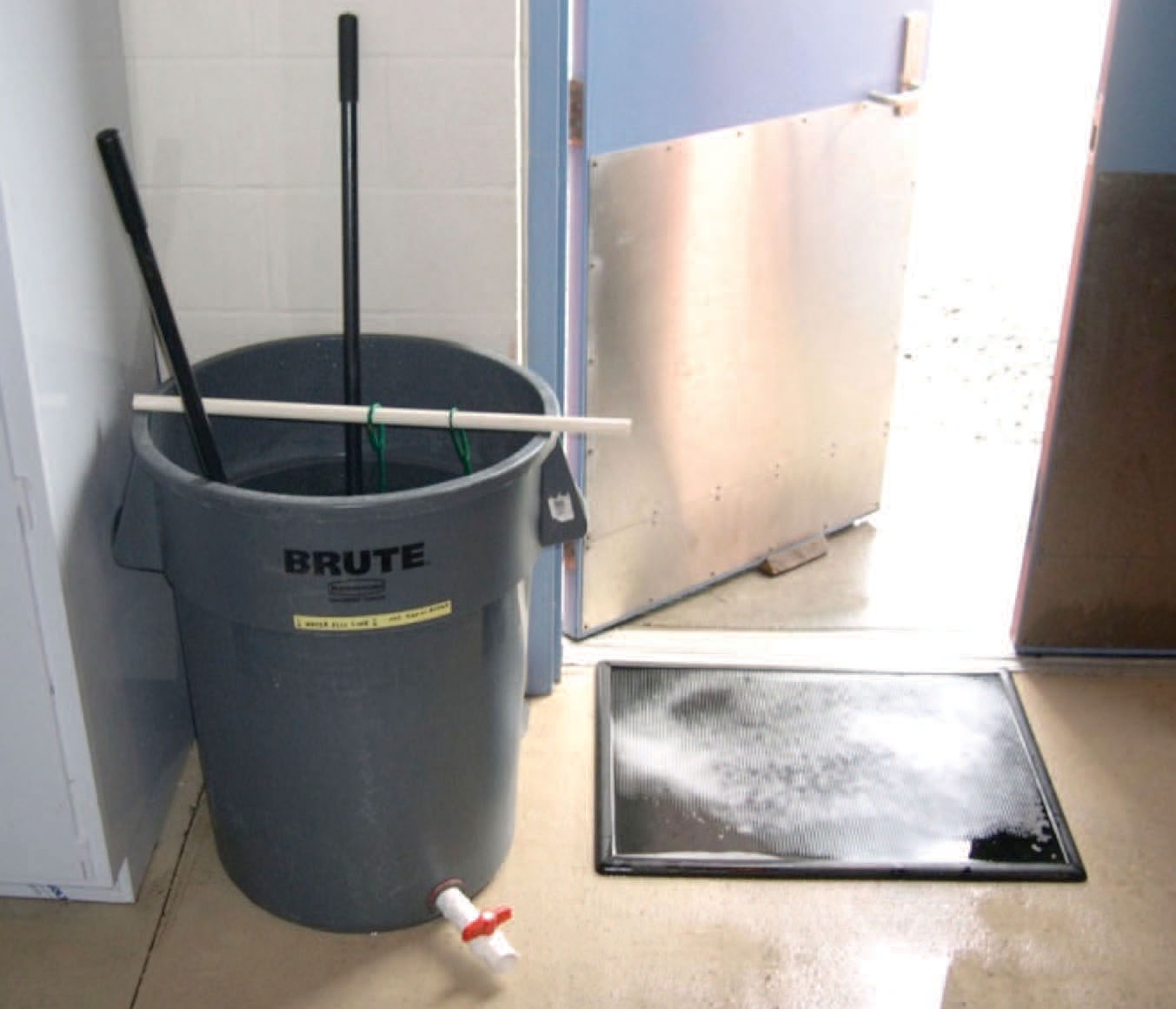 photo of a bucket and footbath in front of a door