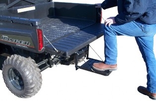 Person mounting hitch step attached to UTV