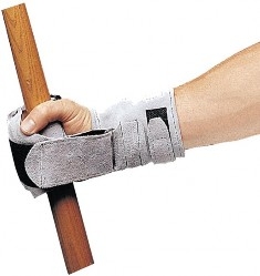 Hand wearing gripping cuff that velcroes closed around a wooden dowel