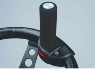 A steering wheel with a single pin spinner on it.