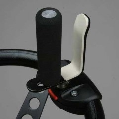 A steering wheel with a V-Grip Spinner, the spinner consists of a single pin and an L-shaped piece of plastic attached by the bottom of the L.