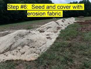 An Image of the  above ground burial soil soil mound covered with erosion fabric.  
