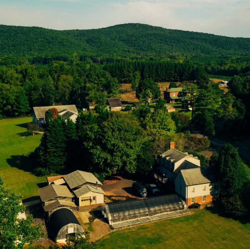 An aerial view of a rural area with several buildings.