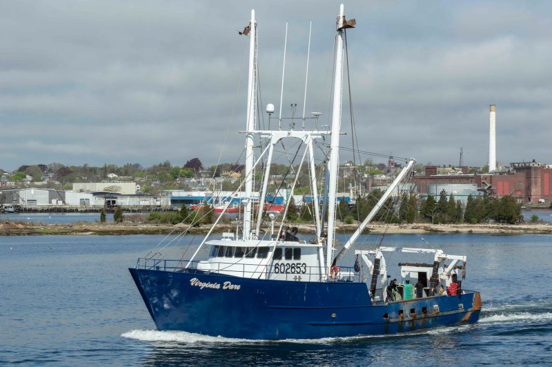 A blue commercial shipping vessel on the water.