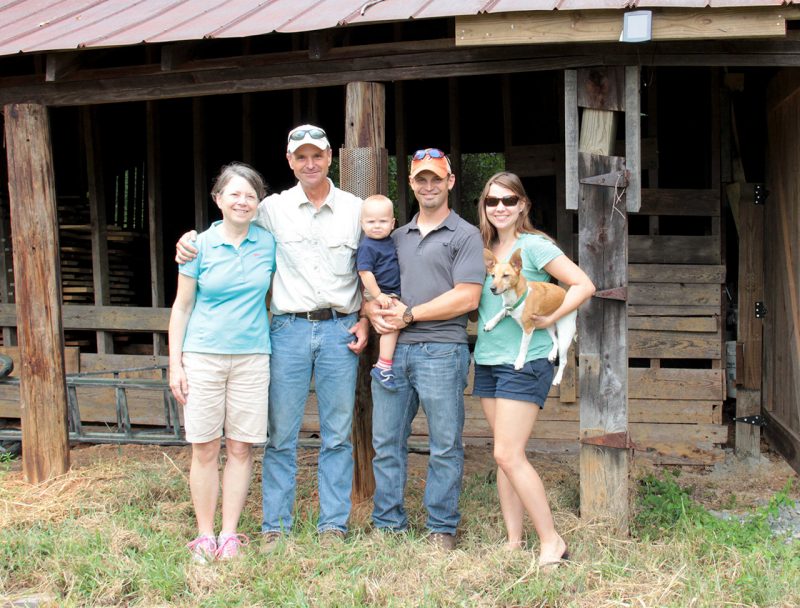 photo of a family in front of a barn