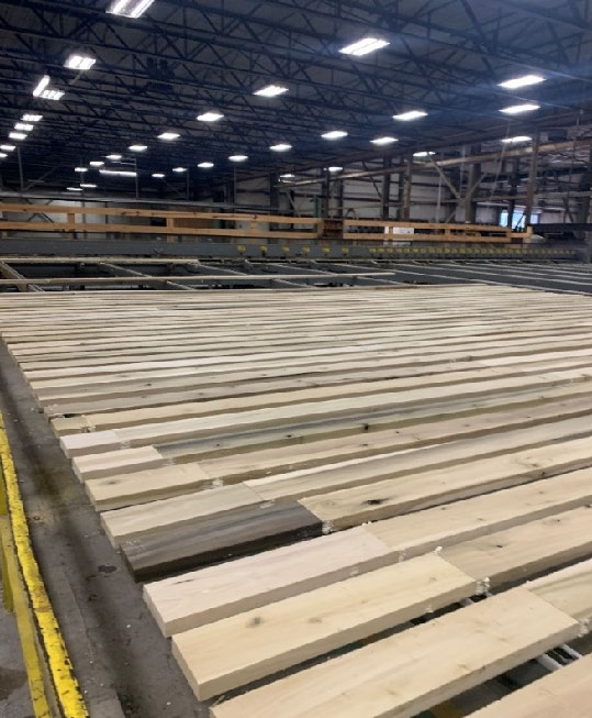 Cut lumber with finger joints laid side by side in a large wearhouse