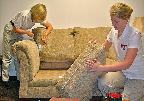 picture of two people inspecting a couches