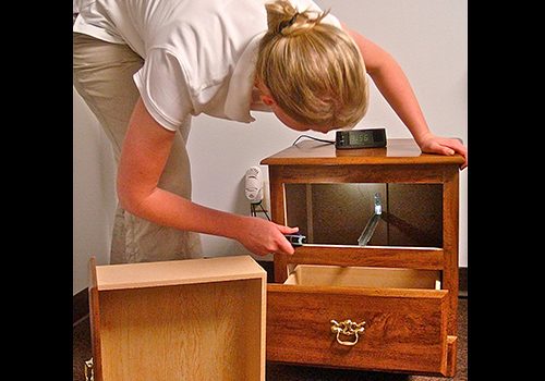 picture of a person checking a nightstand