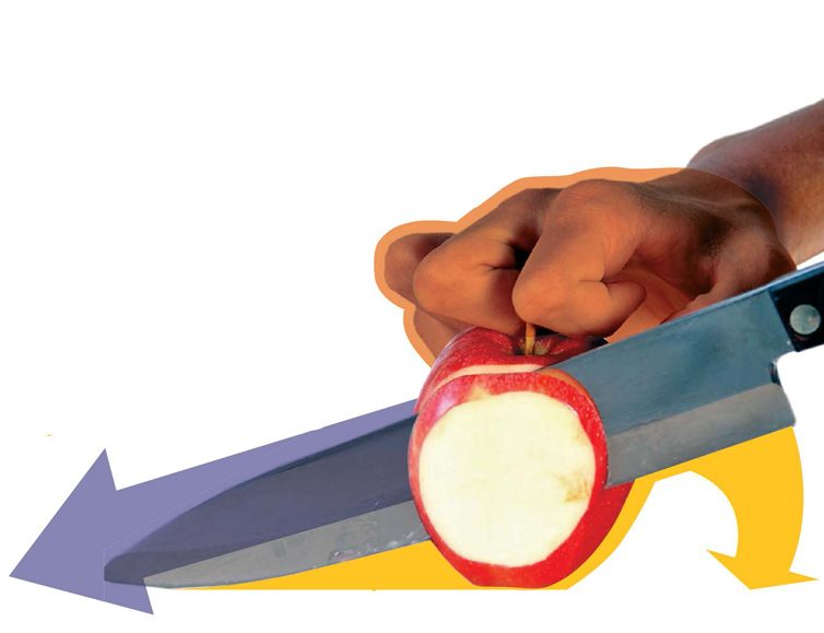 Photo of a person slicing an apple
