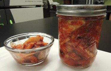 a photo of Kimchi in a jar and a glass container.