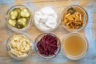 6 bowls of fermented foods on a wood table 