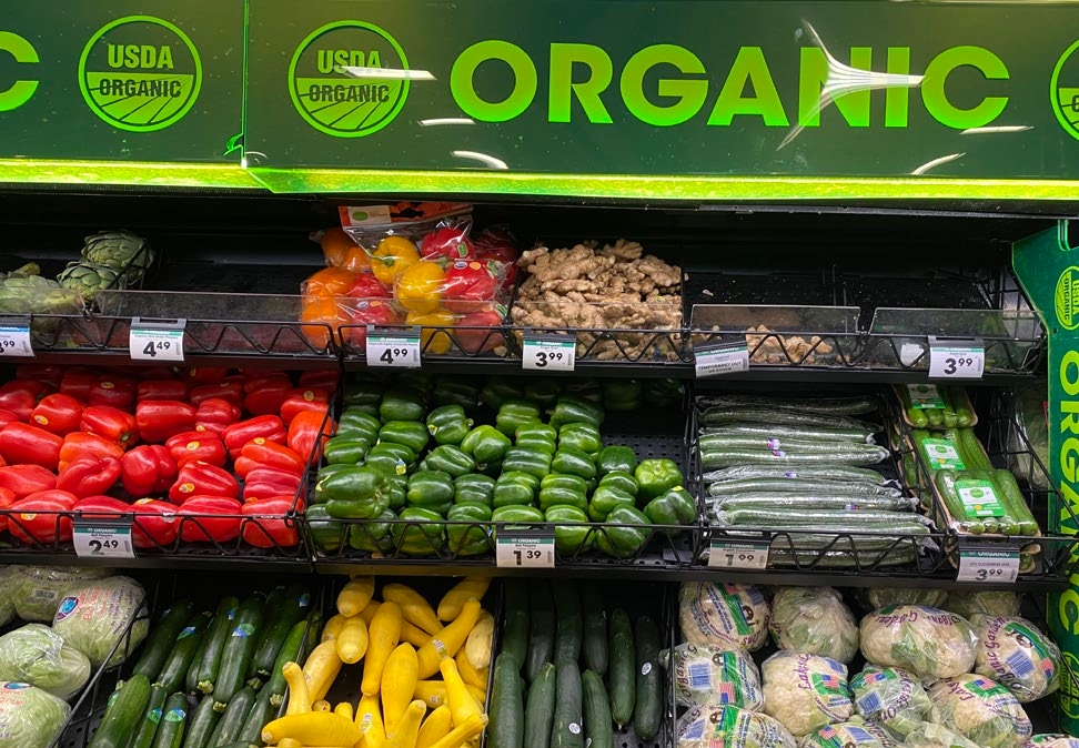 Colorful organic fruits and vegetables on shelves in the grocery store