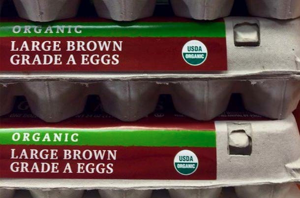 Photograph of a carton of organic large brown grade A eggs.