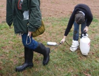 a photo of two people cleaning their boots