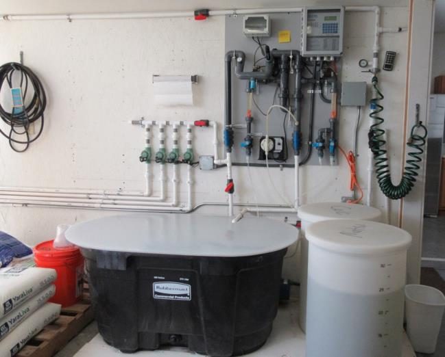 Figure 10. A nutrient tank and acid storage bulk containers shown with control board for the nutrient injection system.
