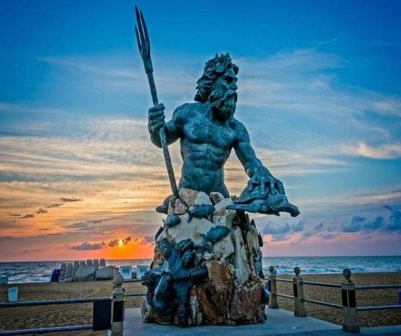 King Neptune Sculpture on the boardwalk at Virginia Beach at sunrise.